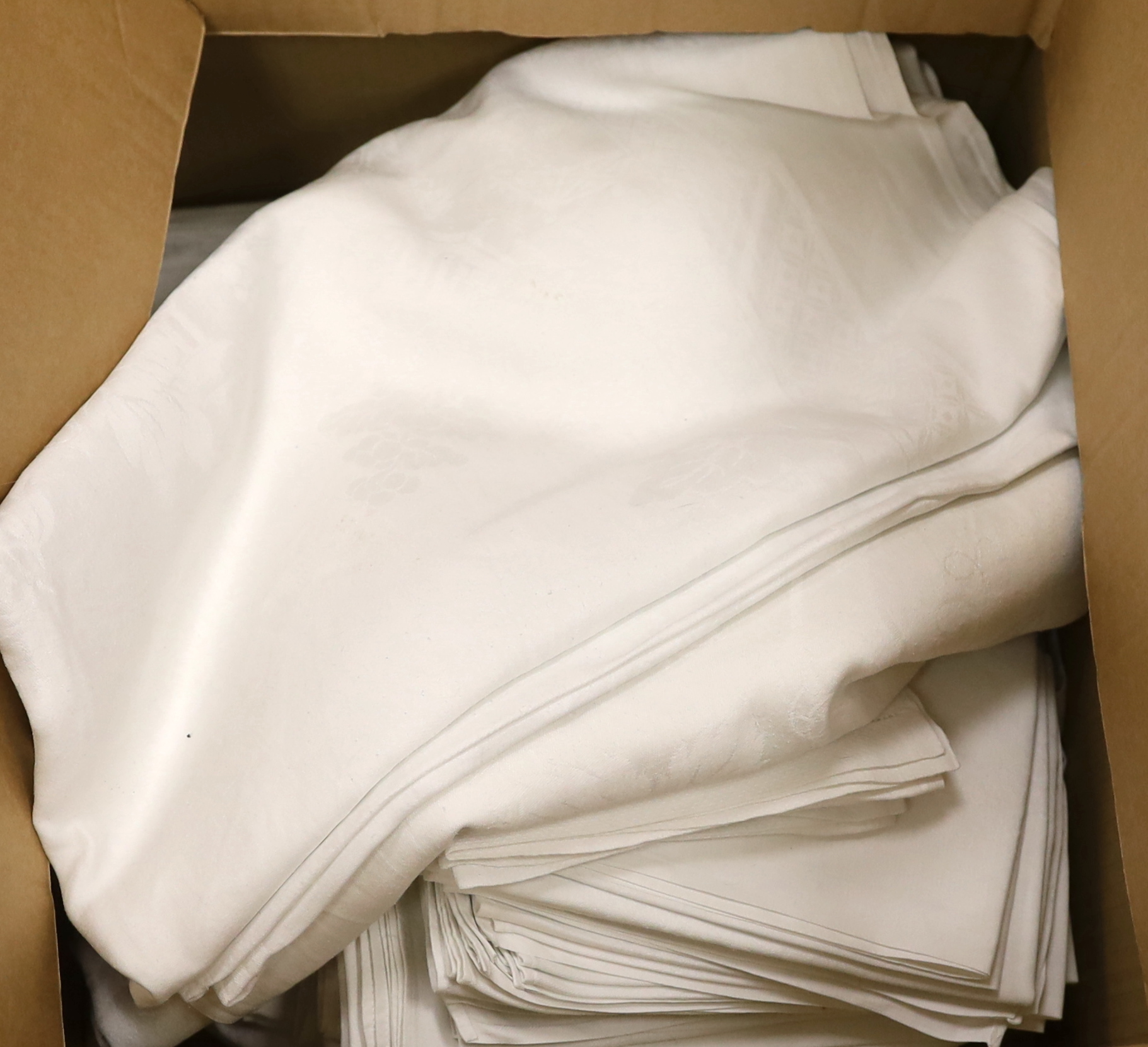 A collection of 20th century damask tablecloths and napkins including a banqueting cloth